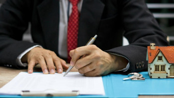 Concept home purchase contract,Businessmen are signing a house purchase contract,The concept of selling a home is signing a contract.