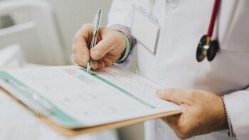 Physician noting down symptoms of a patient