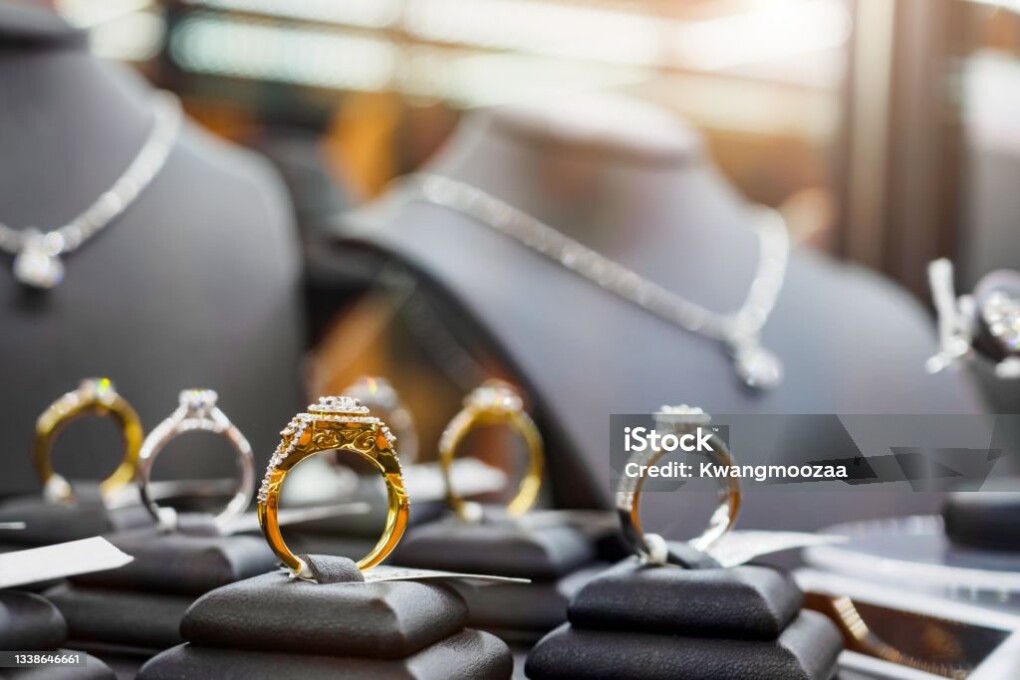 Gold jewelry diamond rings show in luxury retail store window display showcase