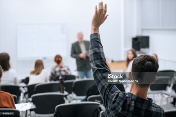 A famous professor has arrived at the university to conduct a special lesson, the student pulls his hand up to ask him a question.