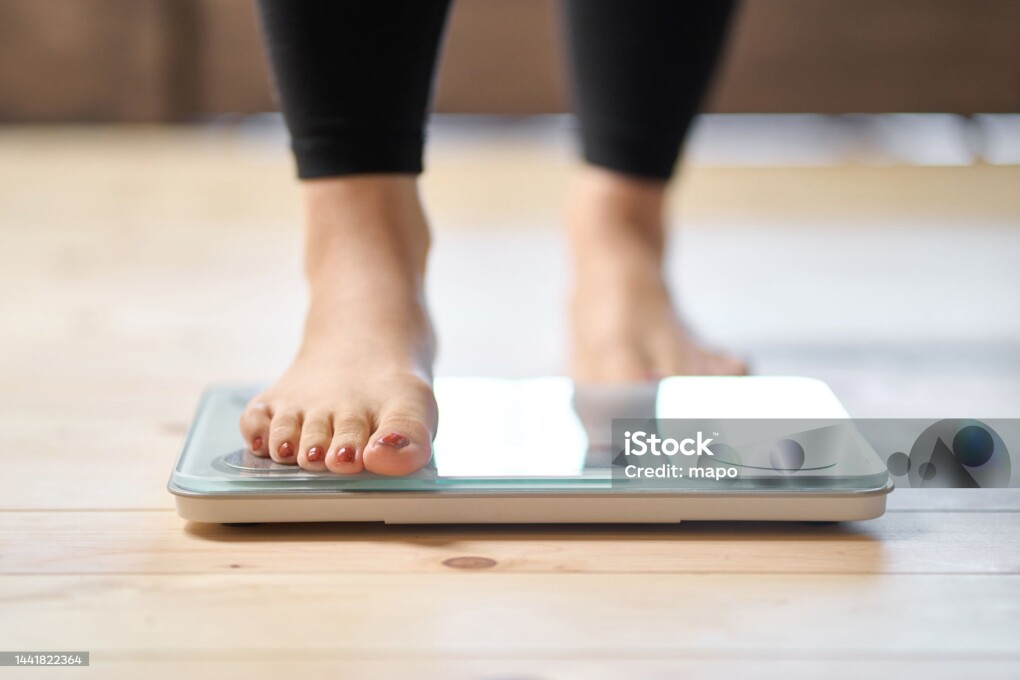 Feet of an Asian woman on a weight scale