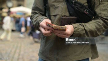 Man On Street Pulls Out Euro From Wallet And Counts Them