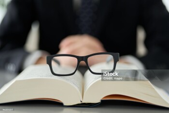 Image of intellectual labor with glasses and dictionaries