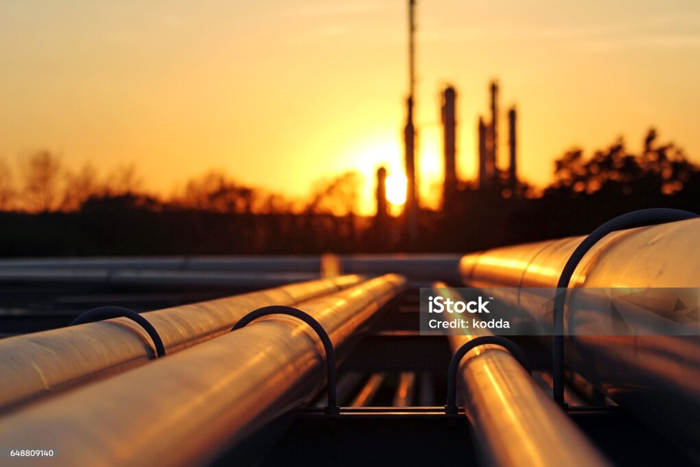 crude oil refinery during sunset with pipeline conection