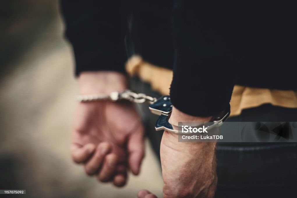 Man in handcuffs behind his back