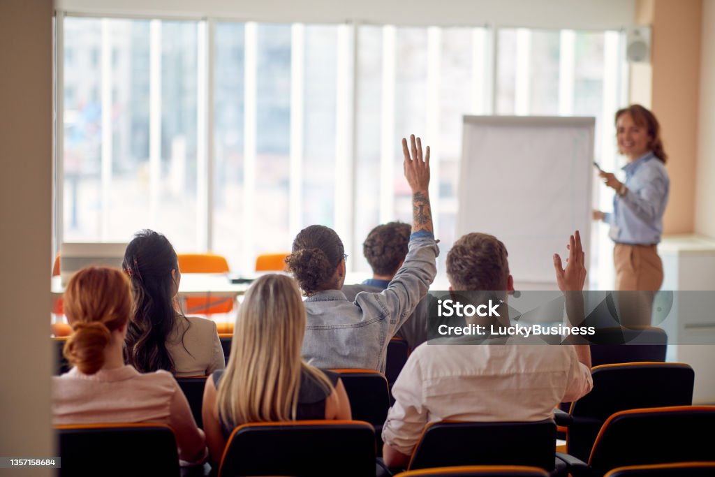 Group of employees are following a presentation in the conference room