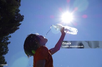 Child pouring water on himself.