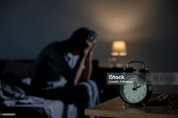 Depressed senior Asian man sitting in bed cannot sleep from insomnia