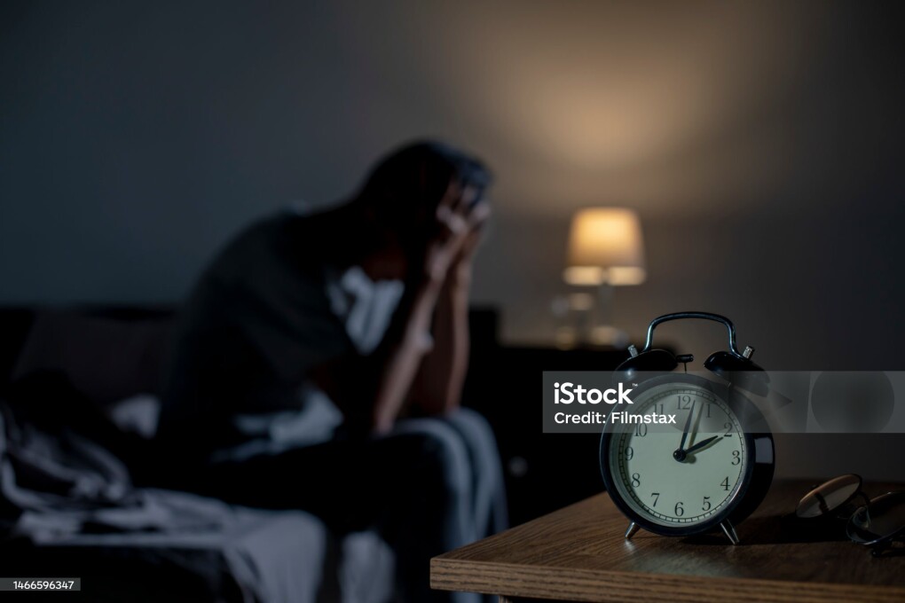Depressed senior Asian man sitting in bed cannot sleep from insomnia