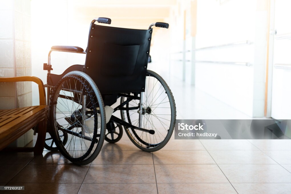 Single wheelchair parked in hospital hallway