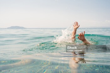 Young man drowning in the sea in Sithonia in Greece.