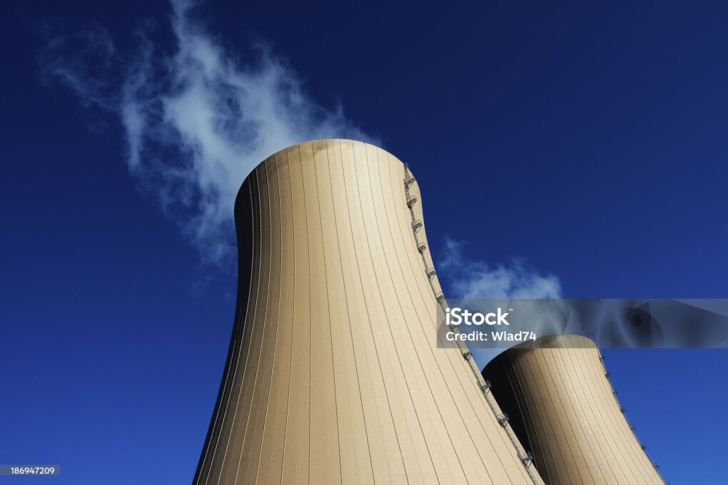 Cooling towers of nuclear power plant against the blue sky