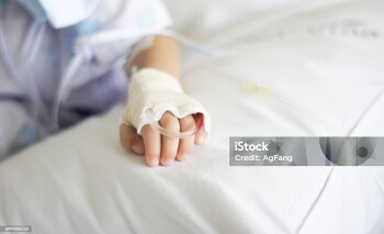 Saline intravenous (iv) drip in a Children's patient hand