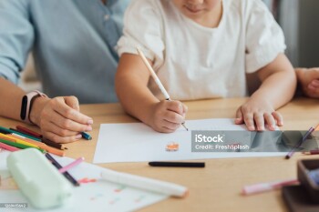 Kids and craft: happy woman drawing with her child, homeschooling concept.