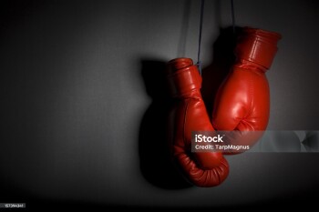 Hanging boxing gloves. Very low key and heavy shadows