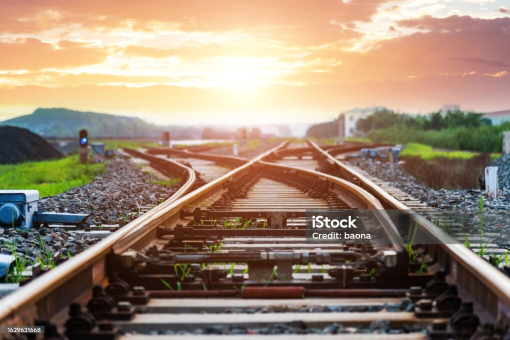 Cross railway tracks at sunset