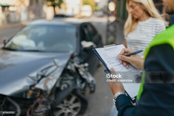 A mature woman in her late 40s expresses her frustration and concerns to her insurance agent, a young man, outdoors. They discuss the imperfections caused by the accident and work together to find a solution to ease her inconvenience.