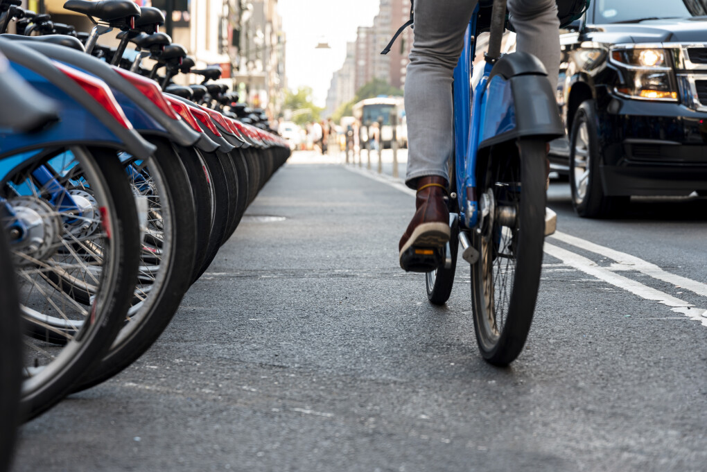 man-cycling-city-from