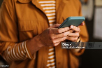 Shot of an unrecognizable woman using a mobile phone indoors