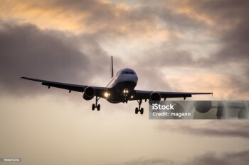 A photography of a jet air plane in sunset sky
