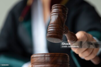Woman holding gavel.
