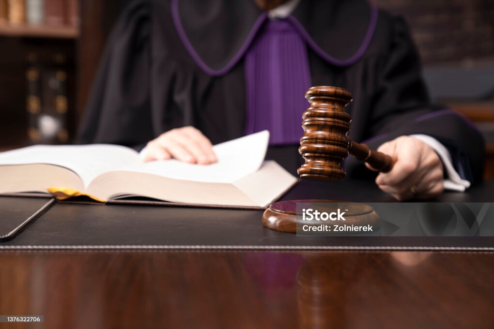 Judge in toga with the gavel during trial.