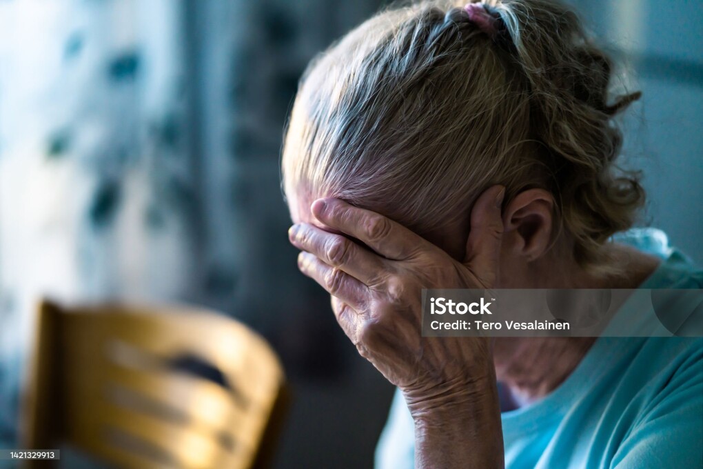 Sad senior old woman. Lonely from loss or sick with headache. Upset patient in retirement home with stress or pain. Alzheimer, depression, senility or dementia. Disorder, migraine or insomnia.