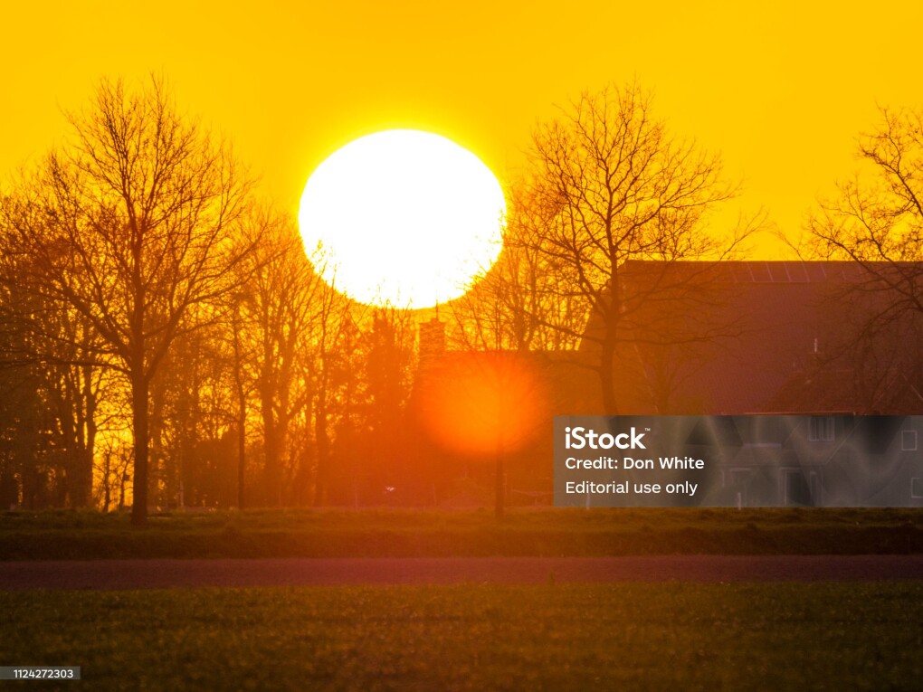 Netherlands Dutch province of Overijssel on April 20, 2016: Dramatic sunset over farm in the Netherlands