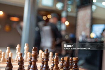 Foreground chess pieces decorating a barber shop, selective focus.