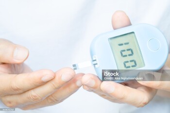 hand of people check diabetes and high blood glucose monitor with digital pressure gauge. Healthcare and Medical concept.
