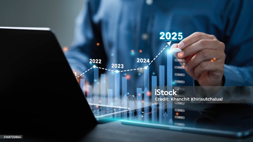 Businessman analyzes the graph of trend market growth in 2025 and plans business growth and profit increase in the year 2025. plan finances of the business