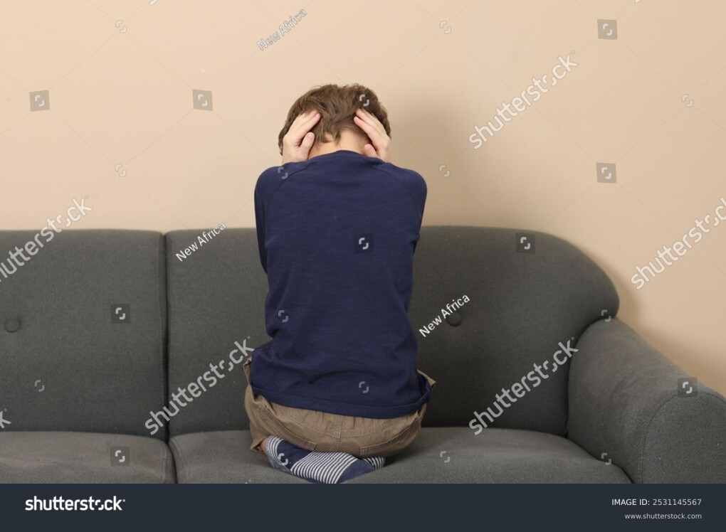 stock-photo-autism-concept-lonely-little-boy-covering-his-ears-on-sofa-at-home-back-view-2531145567