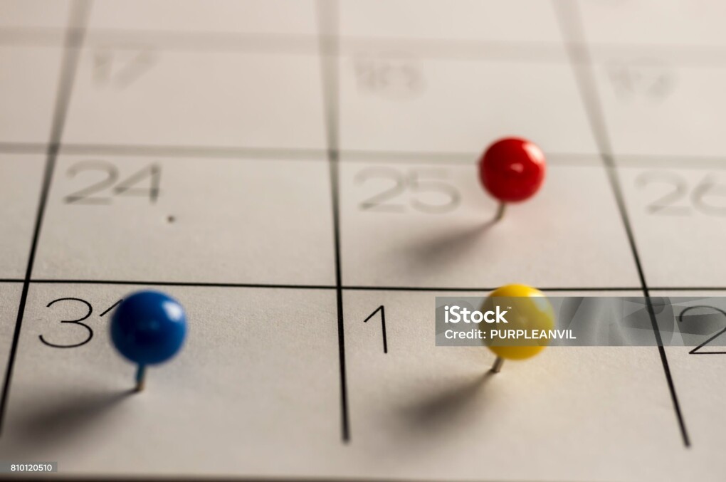 Close up shot of Christmas day New year's eve and day, marked with different color pins on calendar