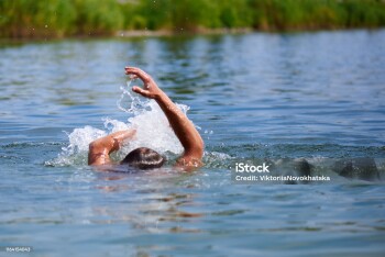 Splashes of water from a drowning man in a pond. Copy space.