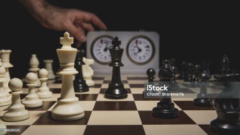 Adult man playing chess on a tournament