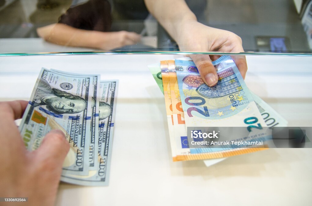 Exchange money, Exchange US dollar or American dollars (USD) for EUR money, A man and women are exchanging dollars for euros.