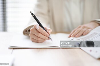Hands of an Asian woman studying in a coworking space