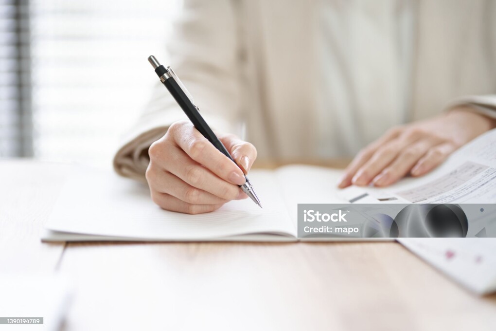 Hands of an Asian woman studying in a coworking space