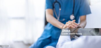Cropped shot of a female nurse hold her senior patient's hand. Giving Support. Doctor helping old patient with Alzheimer's disease. Female carer holding hands of senior man