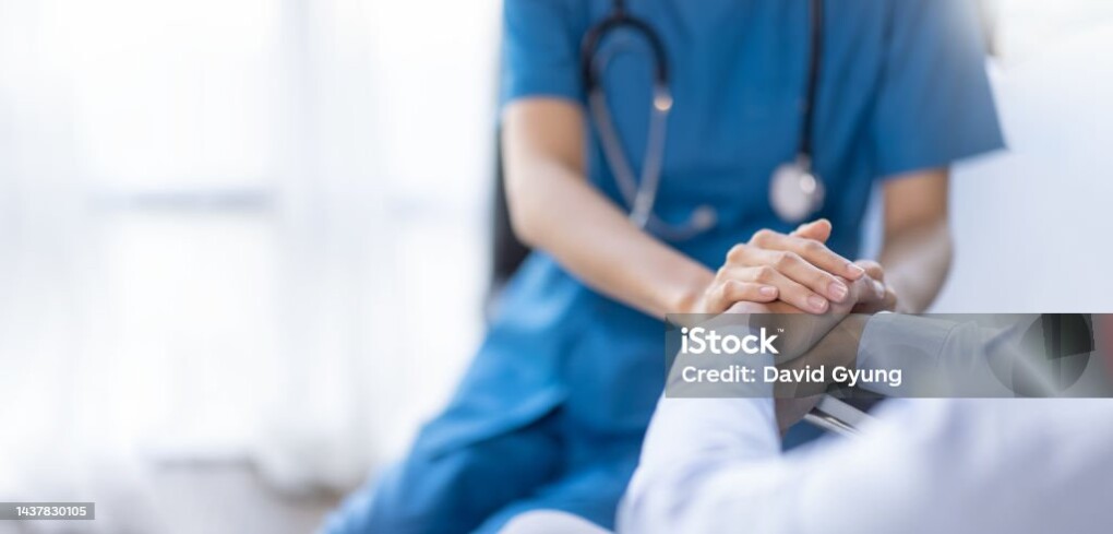 Cropped shot of a female nurse hold her senior patient's hand. Giving Support. Doctor helping old patient with Alzheimer's disease. Female carer holding hands of senior man