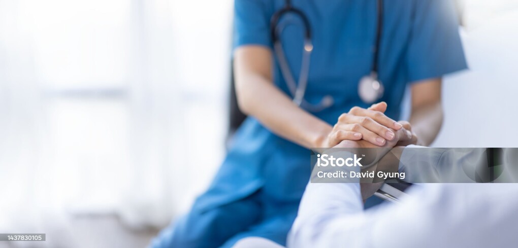Cropped shot of a female nurse hold her senior patient's hand. Giving Support. Doctor helping old patient with Alzheimer's disease. Female carer holding hands of senior man