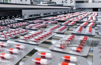 Capsules in blister pack on production line in pharmaceutical industry