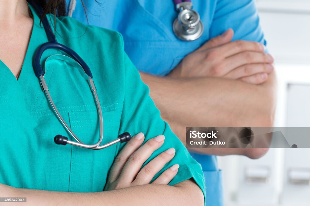 Two doctors standind with their arms crossed on chest ready to work. Healthcare and medical concept.