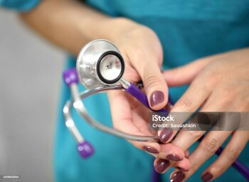 Doctor with stethoscope, close-up.