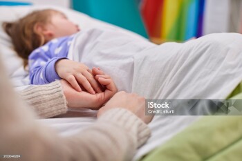 mother and daughter holding hands in hospital