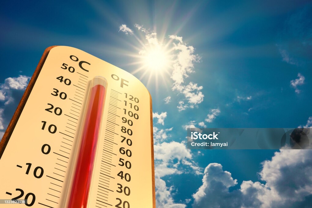climate change, low angle view Thermometer on blue sky with sun shining in summer show increase temperature, concept global warming