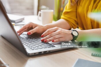 Cropped image of business woman hand working laptop computer in home office