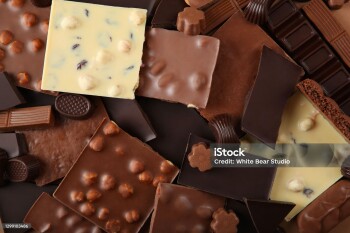 Chocolate products of different types on a colored background close-up with a place for text