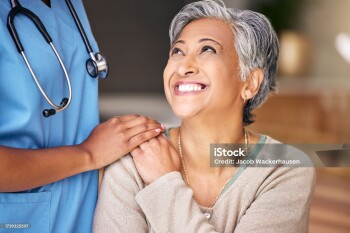Nurse, senior woman and smile with comfort, holding hands or support in nursing home for retirement. Doctor, medic or caregiver with kindness, empathy or gratitude for help, trust or service in house