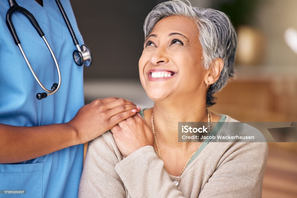 Nurse, senior woman and smile with comfort, holding hands or support in nursing home for retirement. Doctor, medic or caregiver with kindness, empathy or gratitude for help, trust or service in house